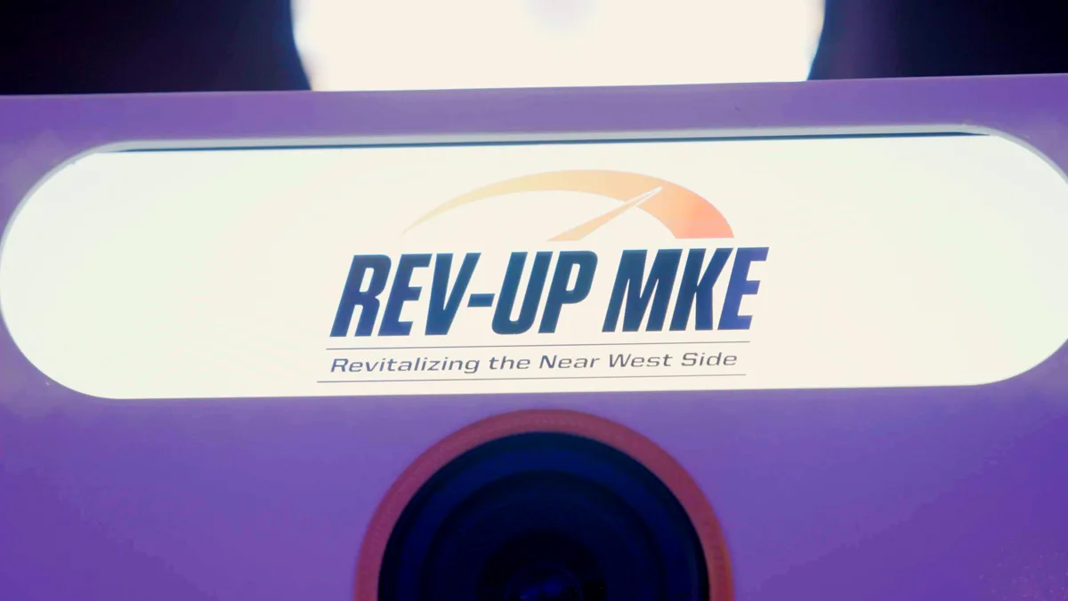 The Booth's billboard screen showing Rev Up MKE