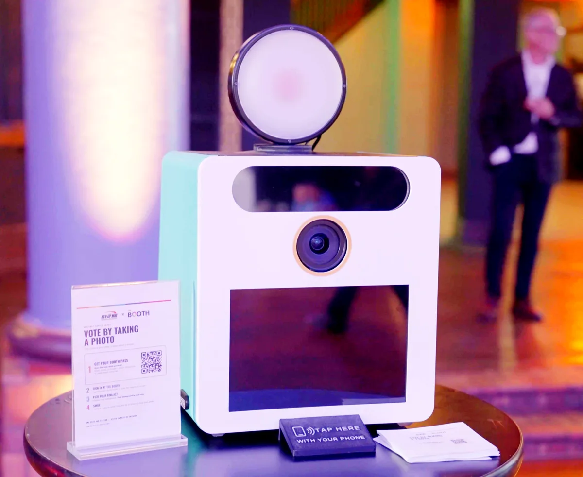 The Booth in white and teal in a Milwaukee ballroom